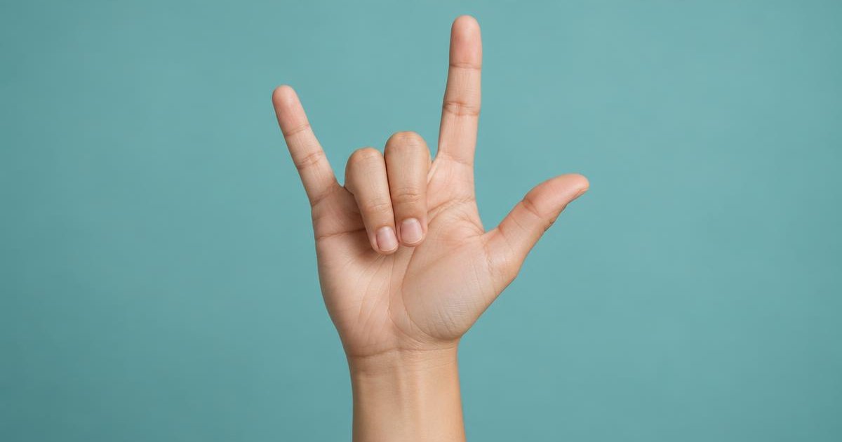 A raised hand with thumb, index finger and pinky extended in the ASL I love you sign